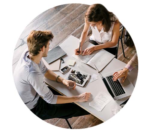 marketing team gathered around laptop