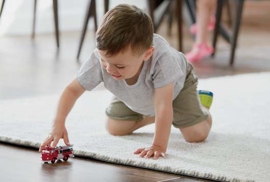 child playing on rug