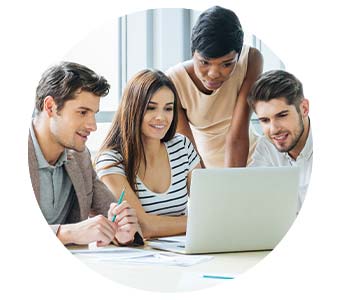 marketing team gathered around laptop