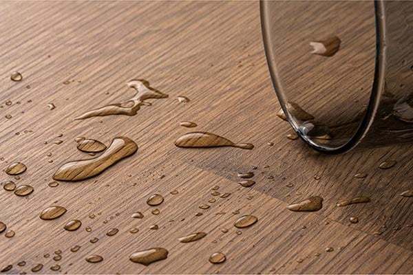 spilled water beading up on surface of floor