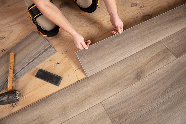 person installing flooring